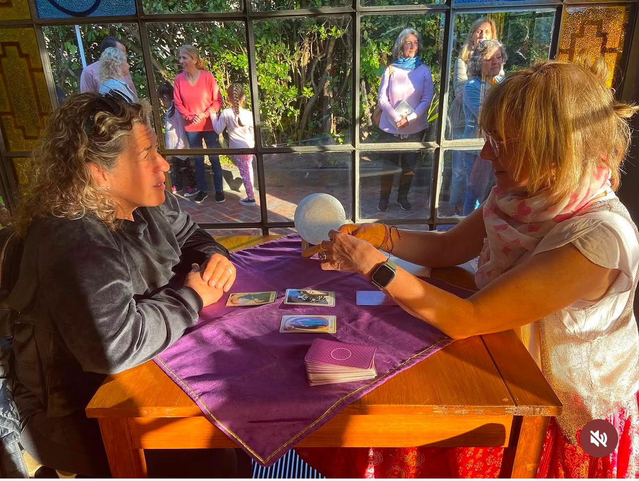 Lau leyendo el Tarot mientras varias personas esperan para participar